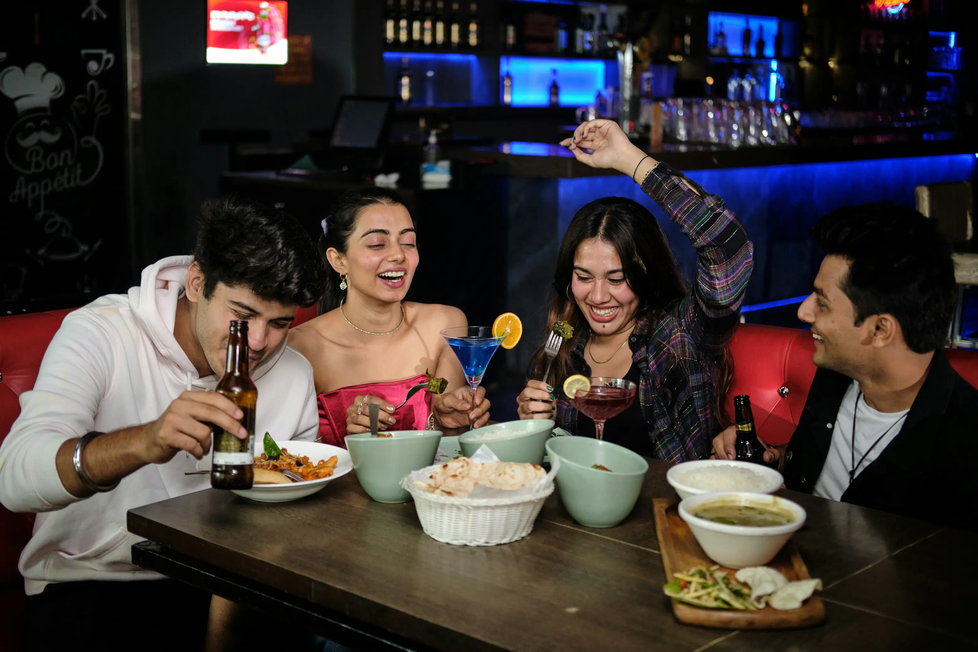 Group of friends laughing at a table